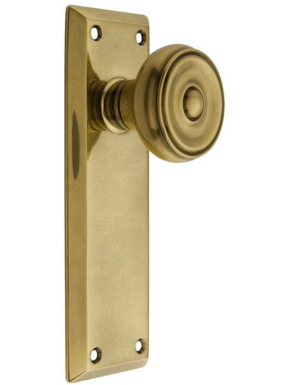 Quincy Door set with Waverly Knobs in Antique Brass.